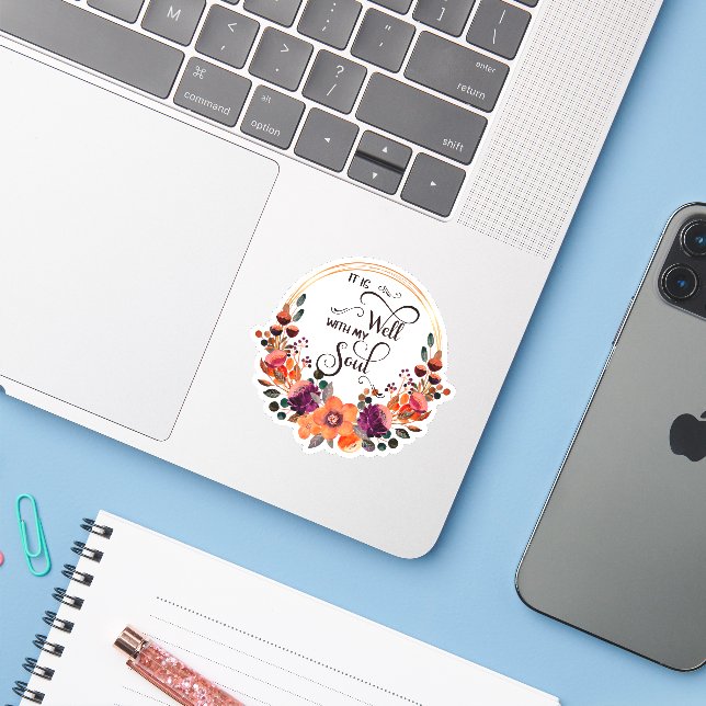 It is well orange and purple floral frame (Laptop w/ iPhone)
