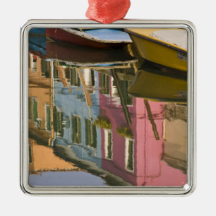 Italy, Burano. Boats on a canal with Metal Tree Decoration