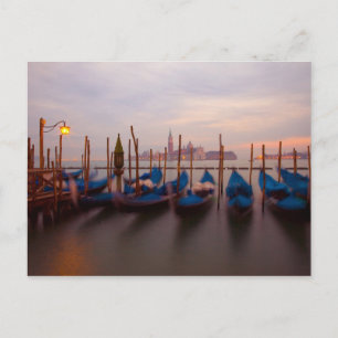 Italy, Venice. Anchored gondolas at twilight. Postcard