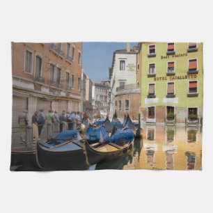 Italy, Venice, gondolas moored along canal Tea Towel