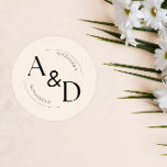 Ivory Black Minimalist Monogram Wedding Classic Round Sticker<br><div class="desc">"Chic sophistication meets timeless style in our 'Ivory Black Minimalist Monogram Wedding Classic Round Sticker.' The elegant ivory backdrop sets the stage for a minimalist masterpiece, featuring a striking black monogram that adds a touch of class. This classic round sticker is the perfect accent for sealing envelopes, embellishing favours, or...</div>