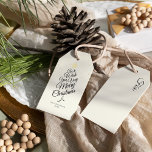 Ivory Very Merry Christmas Tree Family Name Gift Tags<br><div class="desc">This Ivory Very Merry Christmas Tree Family Name Gift Tags design features a sophisticated bright cream backdrop with a blend of simple black lettering and classic calligraphy paired with a minimalist boho styling that strikes a perfect balance between clean modern subtlety and vintage elegance. Embellishing this all beautifully is a...</div>