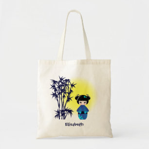 Japanese kokeshi doll at bamboo during sunrise tote bag