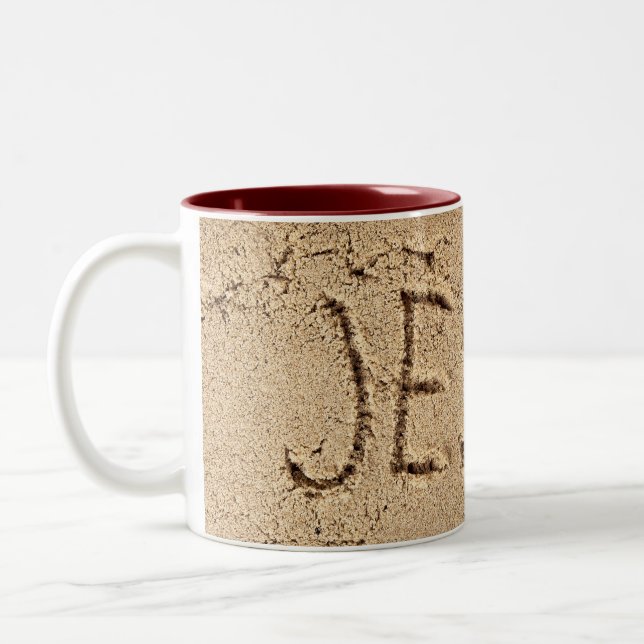 Jesus in beach sand Two-Tone coffee mug (Left)