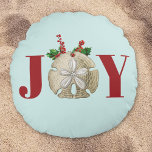 Joy Christmas Sand Dollar Holly Berries Coastal Round Cushion<br><div class="desc">A coastal themed Joy Christmas design featuring a sand dollar framed with the Christmas holly and berries on a light turquoise background. Perfect festive design for the holiday Xmas season.</div>