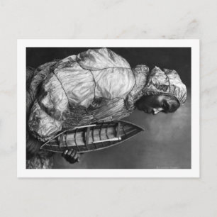 Kayaker wearing water-proof jacket with toy boat postcard