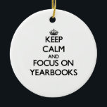Keep Calm and focus on Yearbooks Ceramic Tree Decoration<br><div class="desc">Use the search tool at my store to find other Yearbooks merchandise. Keep Calm and focus on Yearbooks products available on tshirts, sweatshirts, kids shirts, infant onsies, stickers, magnets, and much more Yearbooks clothing fully customisable to your specifications. If you like what you see, please link to my store (www.zazzle.com/thisandthatgifts)...</div>