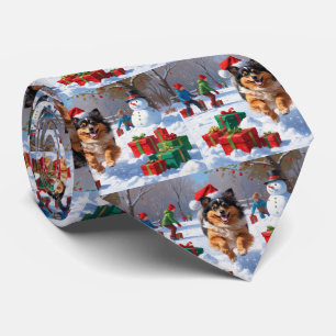 Keeshond Dog Running in Snow with Christmas Hat Tie