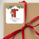 Kids Elf Initial T Christmas Square Sticker<br><div class="desc">Give the gift of personalised charm this Christmas! Our monogram stickers,  featuring Santa's elf hiding behind the letter T,  are a unique and thoughtful way to show your love. Customise with a name,  year and a heartfelt greeting. Make your Christmas gifts stand out!</div>
