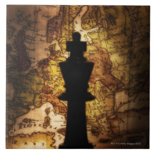 King chess piece on old world map ceramic tile