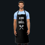 King of the Grill Funny Black White Grilling Apron<br><div class="desc">The perfect apron for the guy who reigns as the supreme monarch of his grill. Two crossed spatulas appear silhouetted in white under the words "King of the Grill" in white on a black background. Makes an ideal birthday or Father's Day gift.</div>