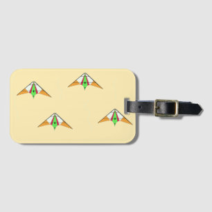 Kites on pale orange luggage tag