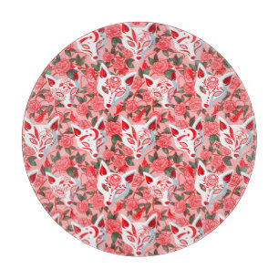 Kitsune masks and blooming camellia on pink cutting board