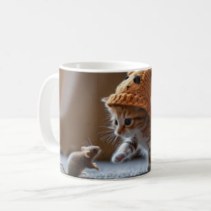 Kitten playing with a small mouse coffee mug