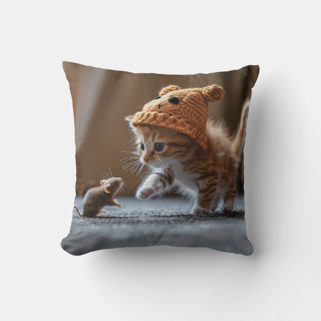 Kitten playing with a small mouse cushion (Front)