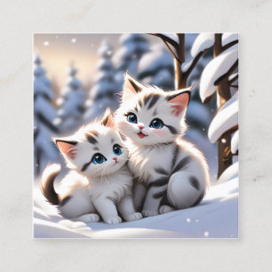 Kittens playing in the white snow is a charming an square business card