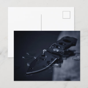 Knife on black postcard