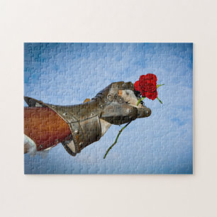 Knight with a heart, hand with a red rose against jigsaw puzzle