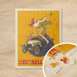 La 15hp Bellanger | Leonetto Cappiello Jigsaw Puzzle<br><div class="desc">La 15hp Bellanger (1921) | Leonetto Cappiello’s 1921 advertising poster for La 15hp Bellanger captures attention with a bold and imaginative design. It features a woman in a flowing yellow dress seated atop a globe, blowing a horn to herald the arrival of a Bellanger car, which dramatically bursts through the...</div>