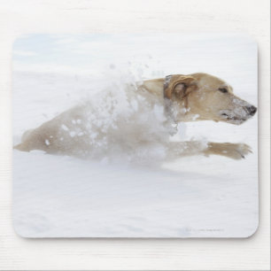 Labrador retriever running through deep snow mouse pad