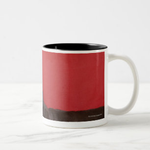 Labrador wearing headphones lying on sofa Two-Tone coffee mug