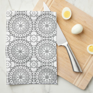 Lacy white squares on a light grey background tea towel