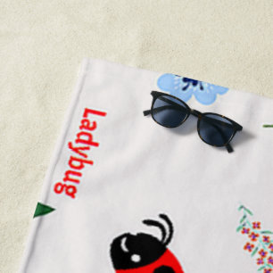 Ladybug pattern on grey beach towel