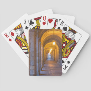 Lamp lit stone hallway, spain playing cards