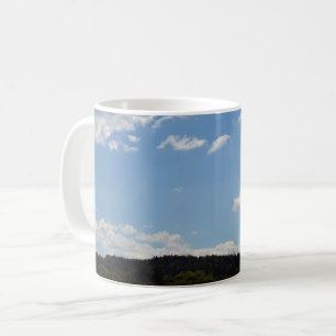 Landscape with green hills, trees & clouds coffee mug