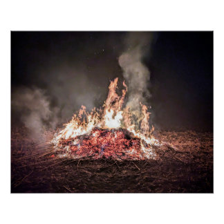 Large bonfire burning at night with high flames poster