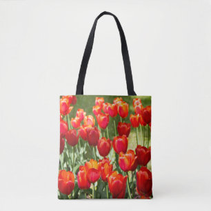 Large field of red tulips tote bag