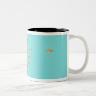 Large group of goldfish facing one lone goldfish Two-Tone coffee mug