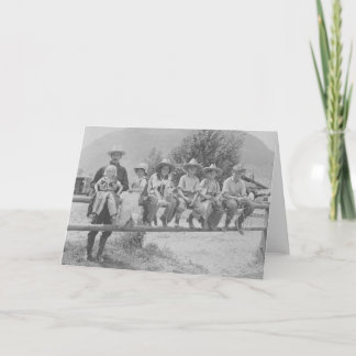 Larry Larom with six children on a fence. Card