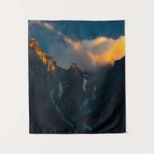 Last breath of sun shining on majestic mountains tapestry