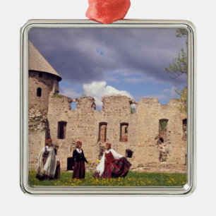 Latvian girls in traditional dress, singing metal ornament