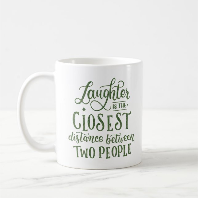LAUGHTER IS THE CLOSEST DISTANCE COFFEE MUG (Left)