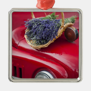 Lavender bunches rest on old farm pickup truck metal tree decoration