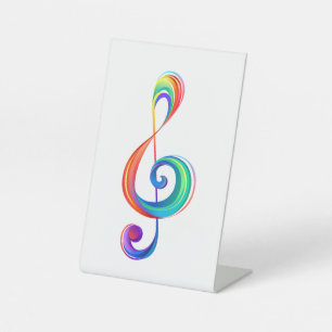 Layered rainbow treble clef pedestal sign