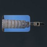 Leaning Tower at Dusk Luggage Tag<br><div class="desc">This captivating photograph showcases the iconic Leaning Tower of Pisa standing elegantly against a deep blue twilight sky in Pisa. The historic marble tower, famous for its unmistakable tilt, is beautifully illuminated, highlighting its intricate Romanesque arches and layered columns. The soft evening light creates a striking contrast between the glowing...</div>