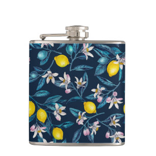 Lemon branches with blossoms and fruit on blue hip flask