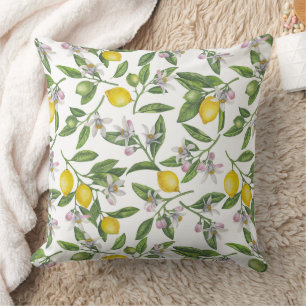 Lemon branches with blossoms and fruit on white cushion