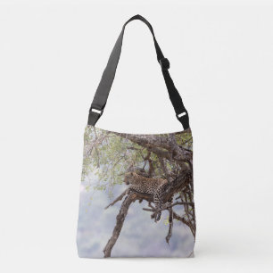 Leopard on a tree crossbody bag