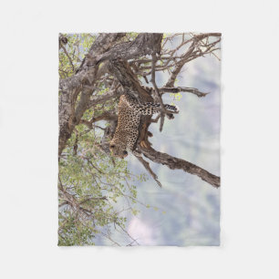 Leopard on a tree fleece blanket