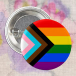 LGBTQ & Pride - Rainbow Progress Flag 3 Cm Round Badge<br><div class="desc">Button: Rainbow Flag & the "Progress" variation adds a chevron along the hoist that features black, brown, light blue, pink, and white stripes to bring those communities (marginalised people of colour, trans individuals, and those living with HIV/AIDS and those who have been lost) to the forefront; "the arrow points to...</div>