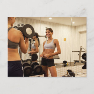 Lifting weights in the gym postcard