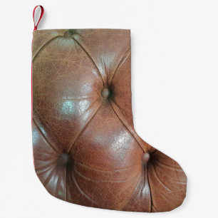 Light on brown leather sofa surface, textureabstra small christmas stocking