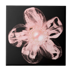Light pink tulle flower on black tile