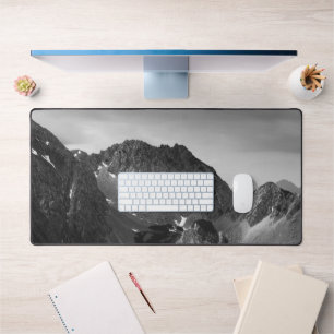 Light shining on majestic mountains desk mat