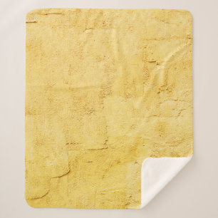 light yellow abstract textured plaster on the wall sherpa blanket