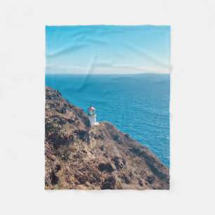 lighthouse on cliff blue ocean Hawaii Fleece Blanket